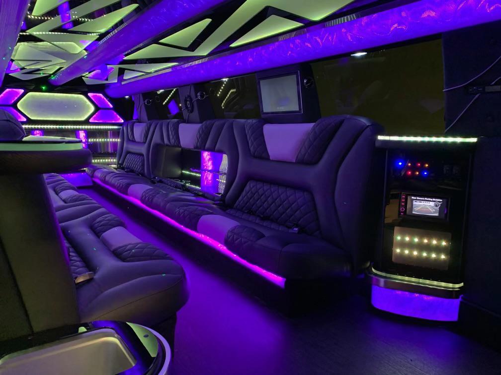 Arvada Limo 1 Limo interior with purple lights and entertainment center.